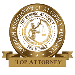 Circular badge featuring a Lady Justice emblem, declaring "Top Ranking Attorney" by the American Association of Attorney Advocates, 2021 Member. A ribbon beneath proudly reads "Top Attorney.