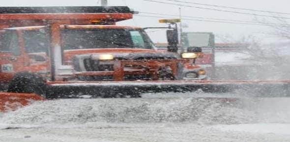 A snow plow efficiently clears the road during a heavy snowfall, ensuring safe passage and preventing potential truck injuries.