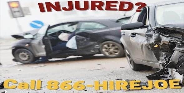 Two damaged cars at the scene of an auto accident with a visible phone number and text asking if injured, highlighting the dangers of mishandling such unexpected events.
