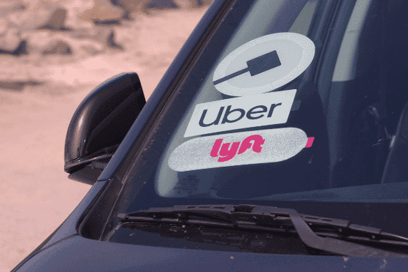 Car windshield with Uber and Lyft stickers, ideal for those seeking legal help for rideshare accident victims.