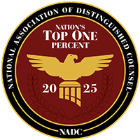 Circular emblem with a gold eagle and scales, "Nation's Top One Percent 2025," and "National Association of Distinguished Counsel (NADC)" proudly displayed around the border.